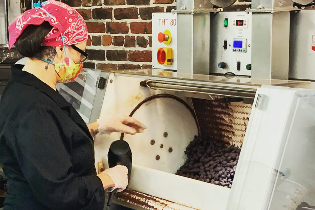 Photo of someone manning chocolate machinery